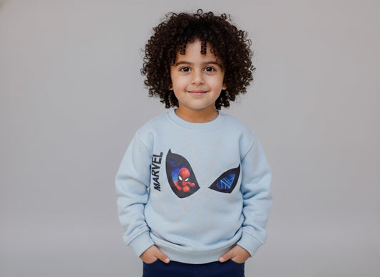 Child wearing a light blue Marvel sweatshirt with a Spider-Man design on a gray background