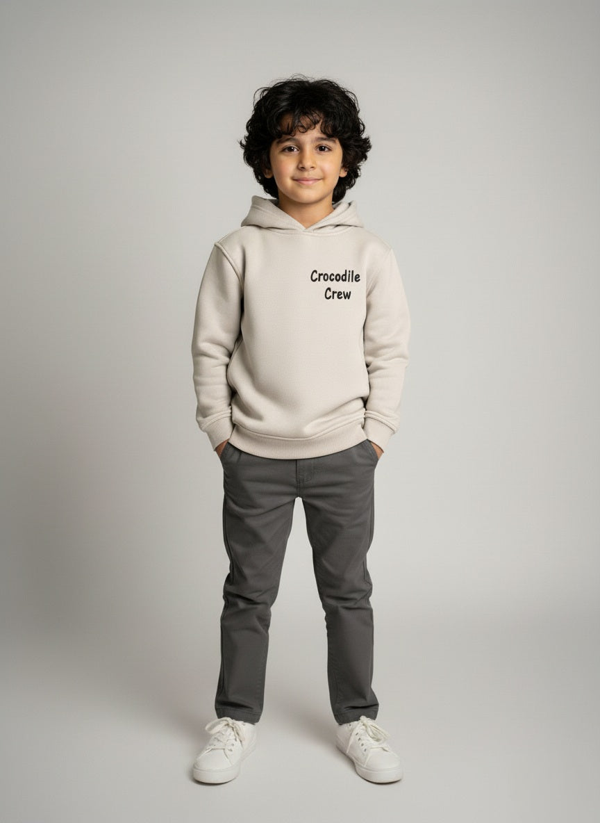 Child wearing a Gray hoodie with 'Crocodile Crew' text on a gray background