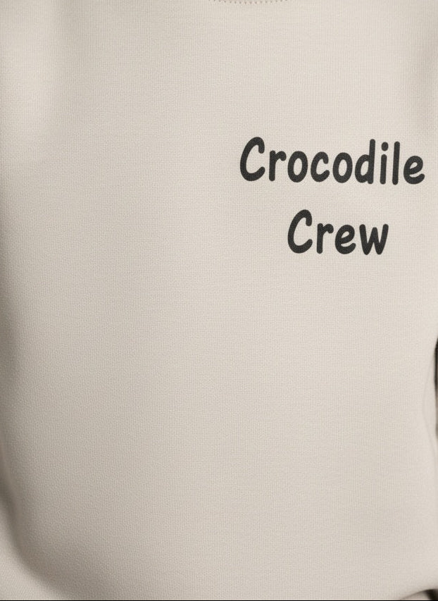 Gray hoodie with 'Crocodile Crew' text on a plain background