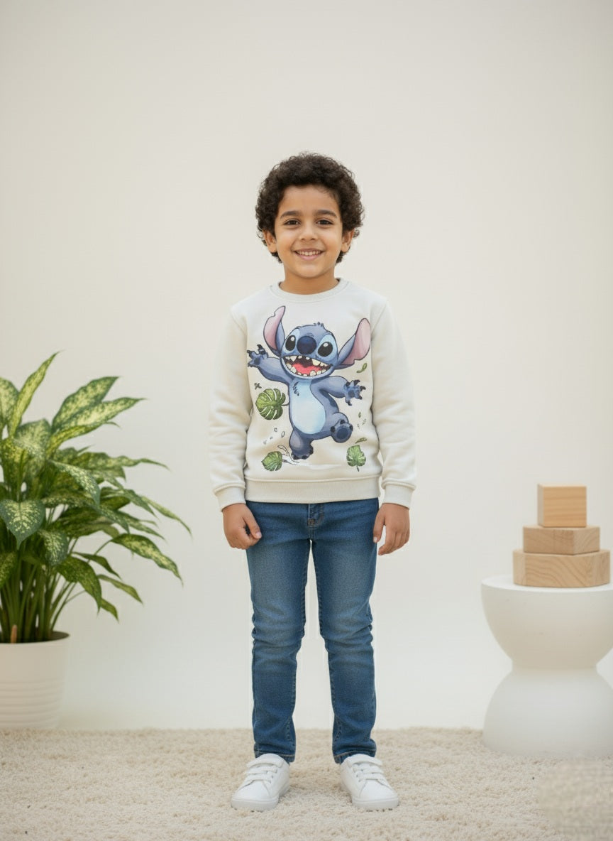 Child wearing a gray sweatshirt with a stitch cartoon character, standing in a room with a plant and blocks.