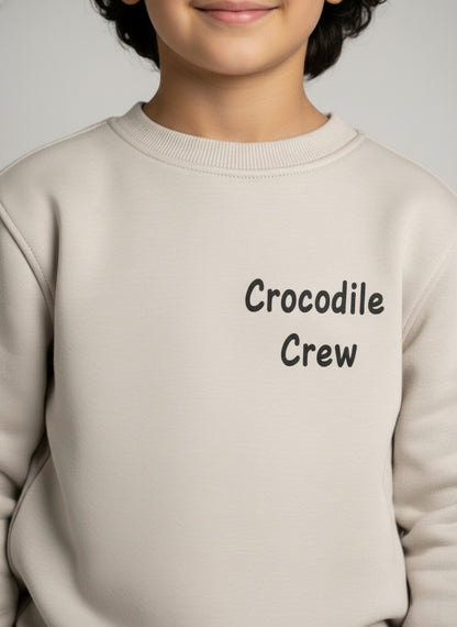 Gray sweatshirt with 'Crocodile Crew' text on a plain background