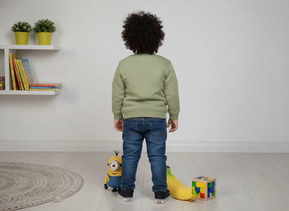 Child standing in a room with toys and a shelf in the background