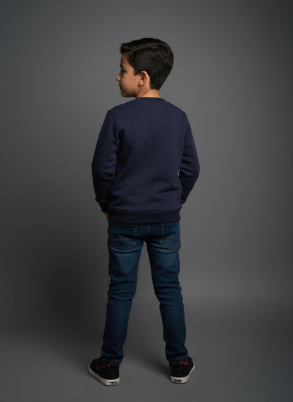 Child wearing a navy blue cotton sweatshirt and jeans on a gray background- zoonikid
