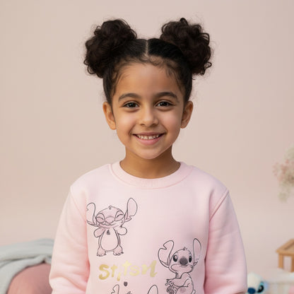 Young girl wearing a pink 'Stitch' sweatshirt with a light background